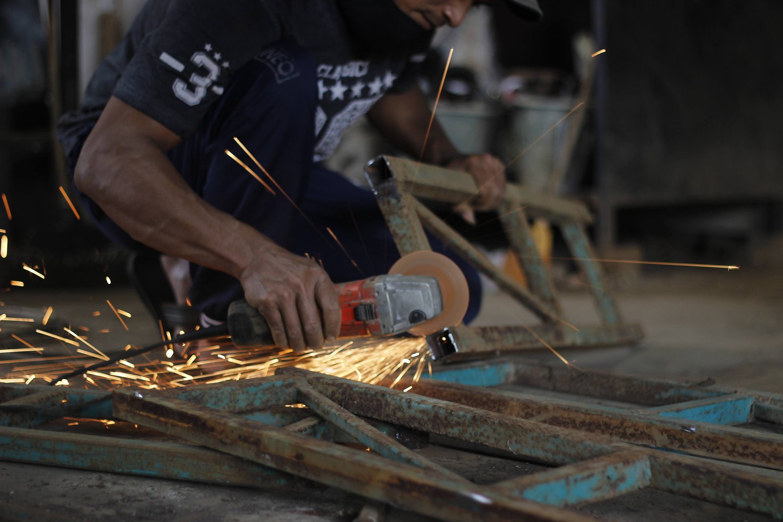 A grinder throwing sparks while working metal